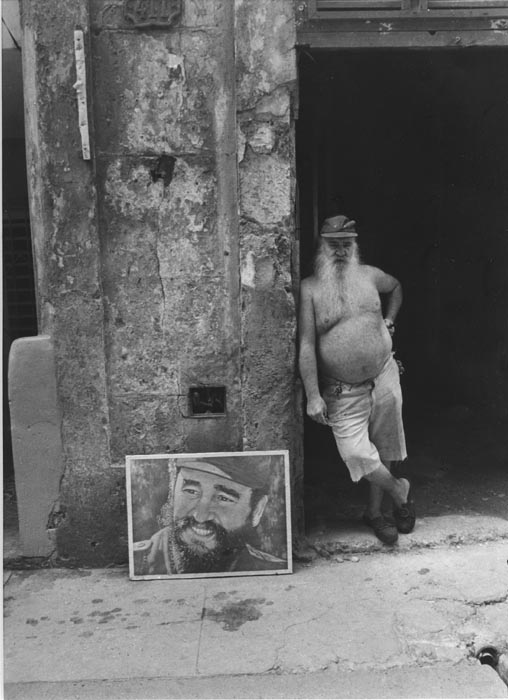 Eddy Garaicoa - Man Standing Beside Poster of Fidel, Cuba