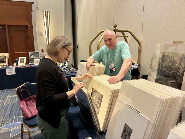 Diane Waggoner, Curator of Photographs at the National Gallery of Art, peruses the offerings at Alex Novak's table at last year's show in Hartford. (Photo by Dave Fondiller) Diane Waggoner, Curator of Photographs at the National Gallery of Art, peruses the offerings at Alex Novak's table at last year's show in Hartford. (Photo by Dave Fondiller)