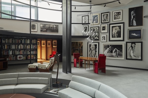 Living room. On the walls; photographs by Paolo Gioli, Urs Lüti, Joel-Peter Witkin, Bettina Rheims, Bill Brandt, Herb Ritts, Henry Callahan and others. White armchair with ottoman model P110-Canada, designed by Osvaldo Borsani, Italy 1969. Red chairs designed by Carlo Scarpa, Italy circa 1950. Dining table designed by Gio Ponti, USA, circa 1950. Ceiling lamp designed by Luigi Caccia Dominioni, Italy 1967. Prestige Club, Fiji Islands, circa 1820. (Photo courtesy of Casa Museo Molinario Colombari)